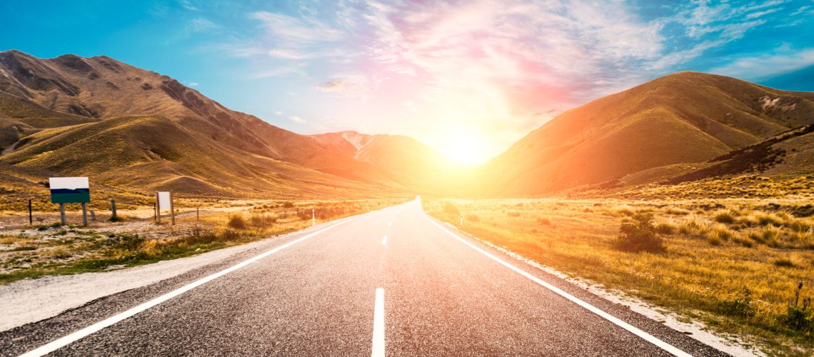 Picturesque landscape scene and sunrise above road